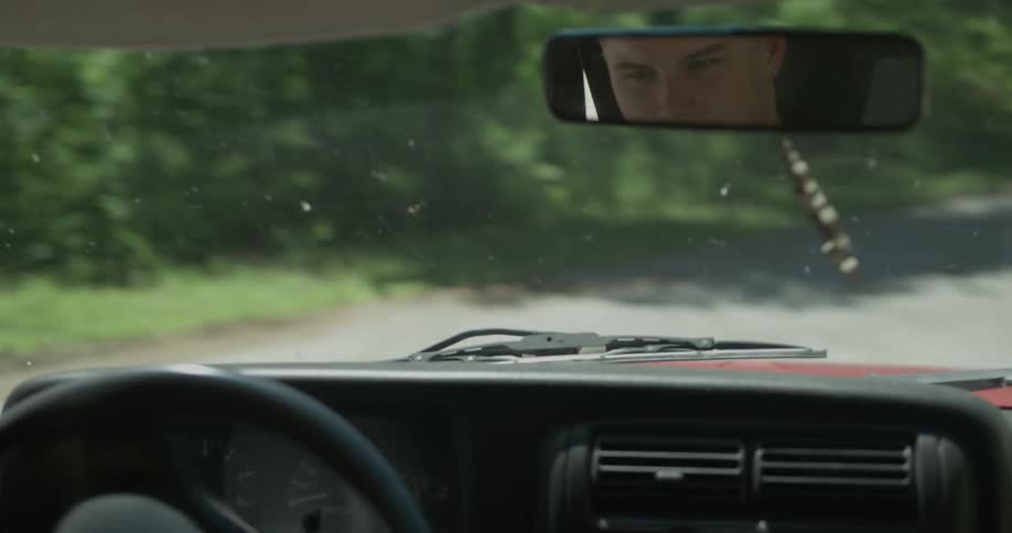 A man makes a turn on a dirt road