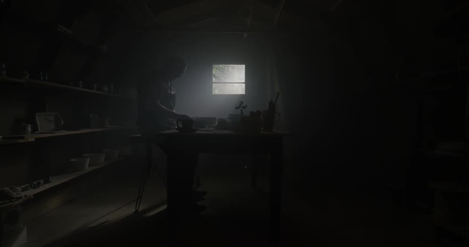 A man is working in a dark room