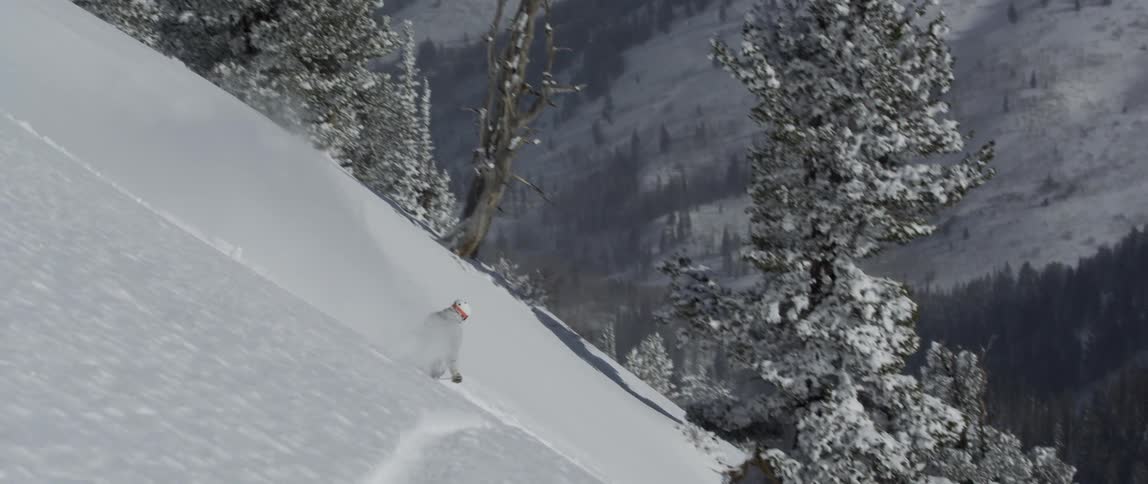 A person skis down a steep slope