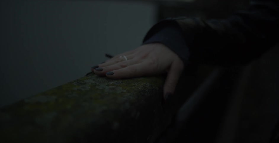 Close up of woman's hands clasped on a ledge