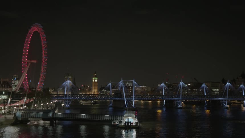 City lit up at night next to a river