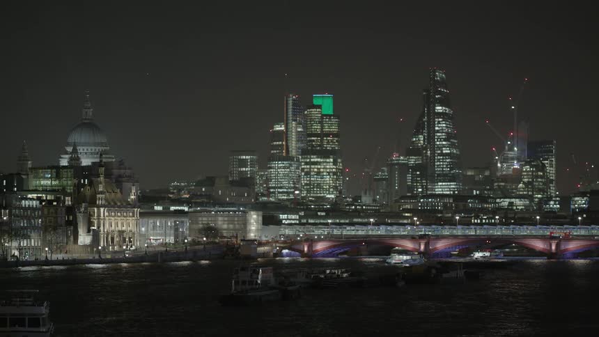 A city skyline is being filmed at night