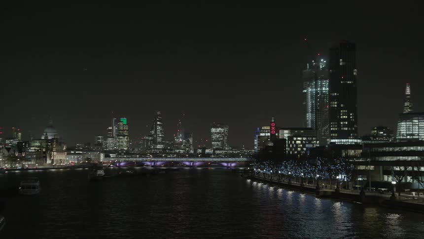 The water is calm around this city at night