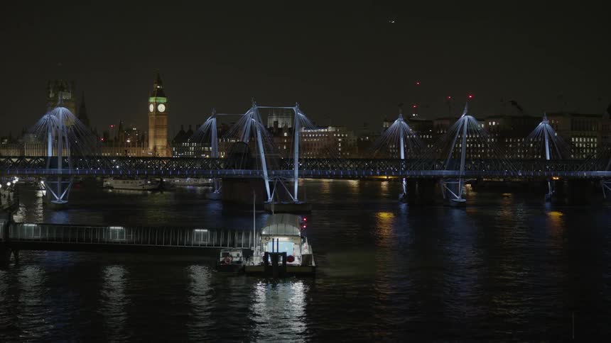 Water ripples and flows in front of city buildings at night