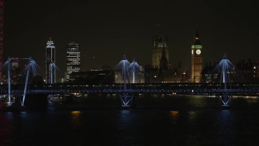 City lit up at night next to a river