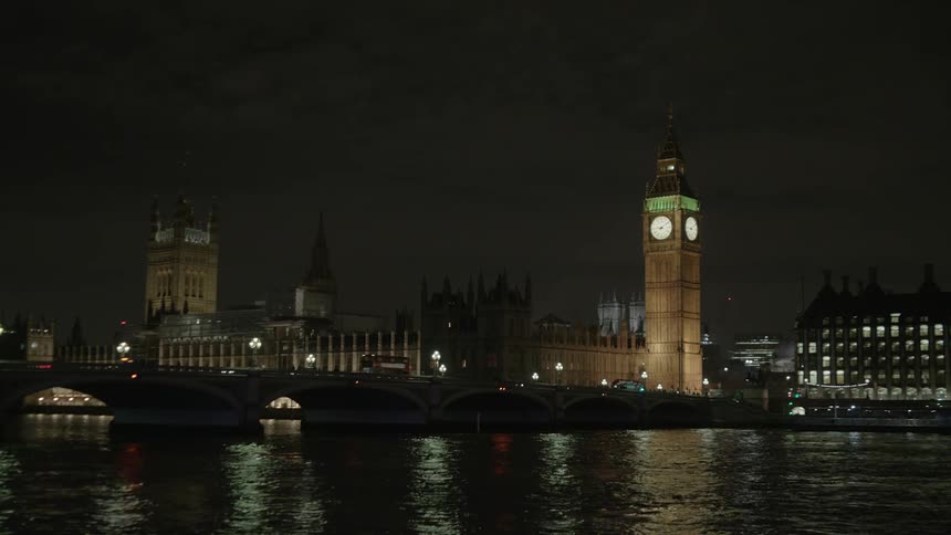 City lit up at night next to a river
