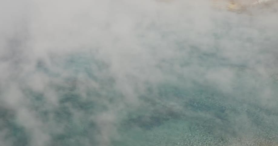 Steam floats over a body of water