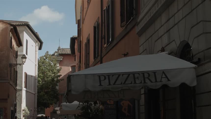 The material on an awning for a pizza place blows in the breeze