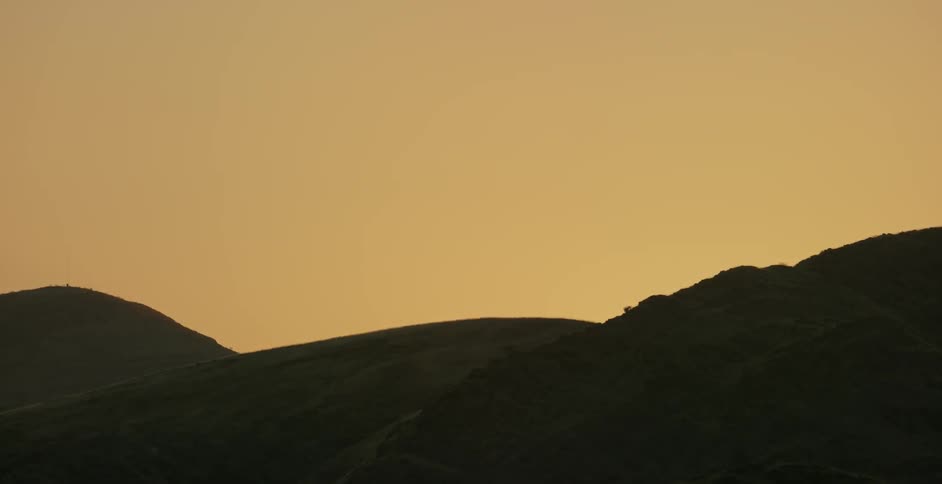Silhouette of sand dunes at sunset
