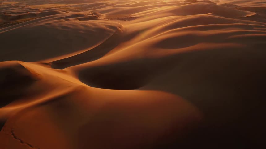 Desert dunes are being filmed from a drone