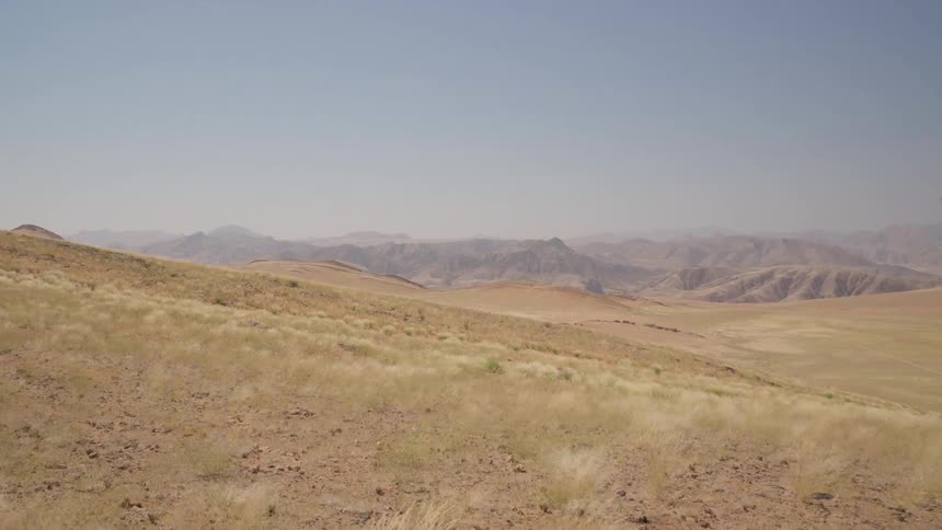 The hills are covered with green grass and rocks