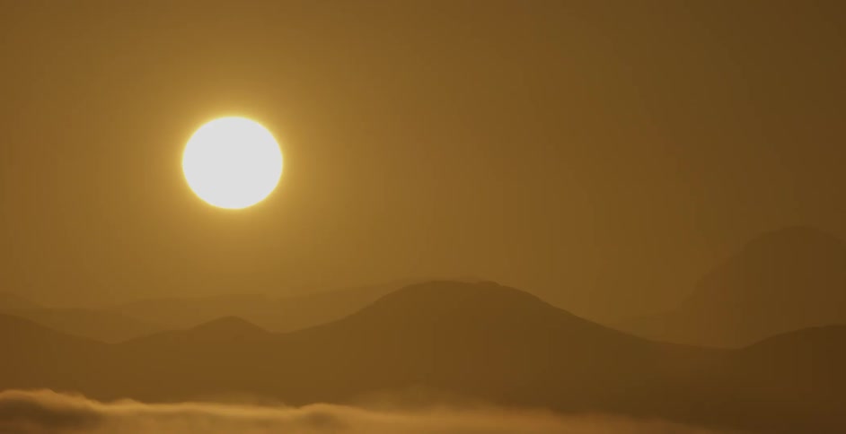 The sun rises over mountains