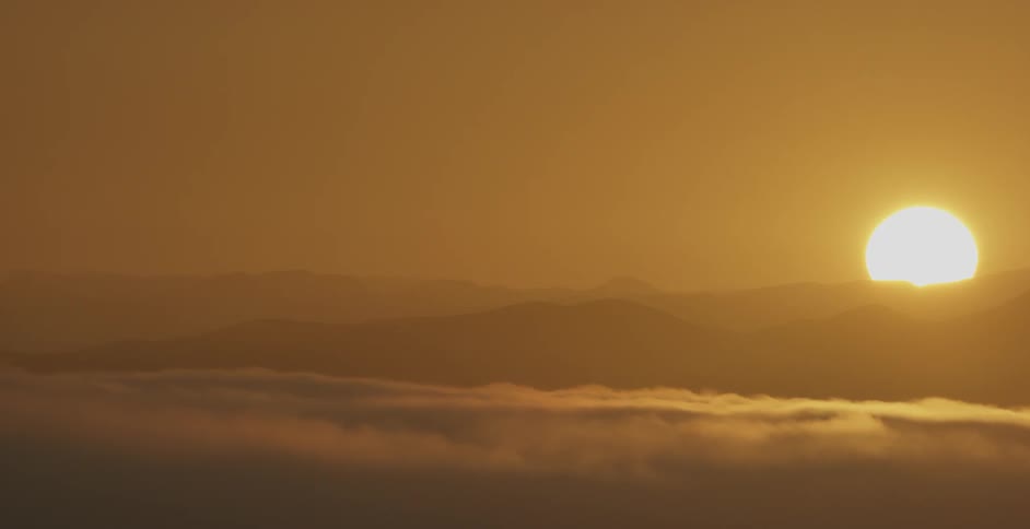The clouds are low to the top of the mountains at dawn