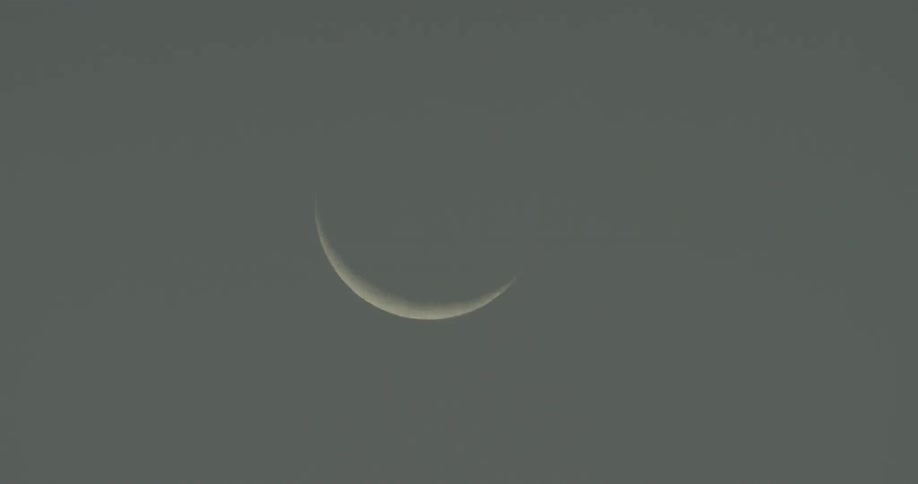 A crescent moon is shown in the sky