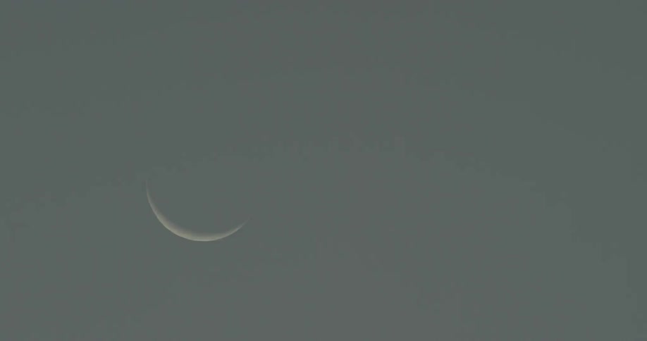 A crescent moon is shown in the sky