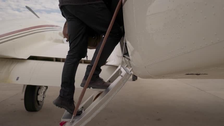 Man climbs aboard a small airplane