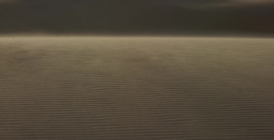 Wind blows gently over the desert