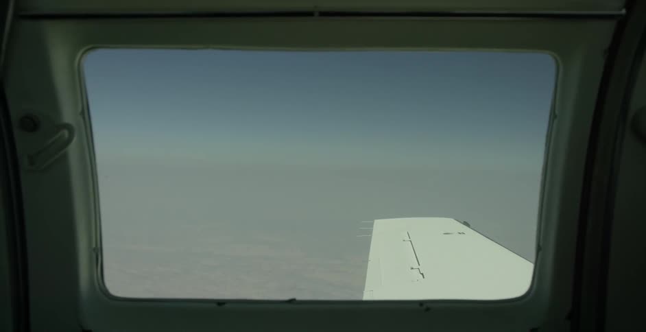 The clouds are being filmed from inside a plane