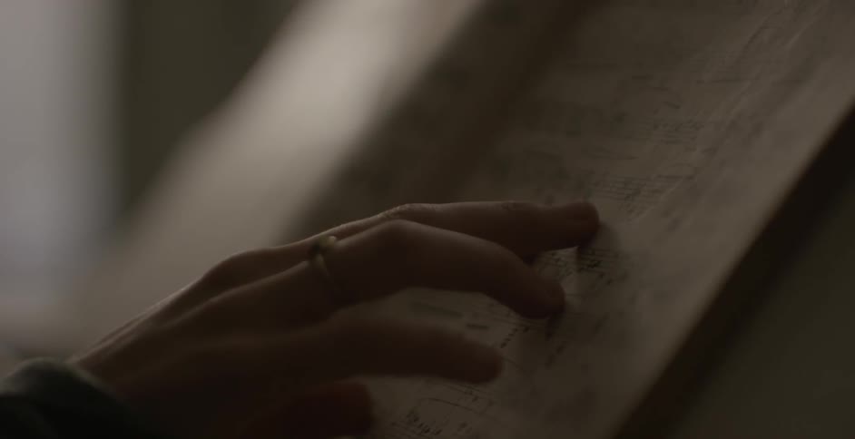 Someone is running their finger along a book