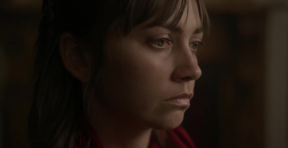 A woman is looking sad when someone comes and sits next to her