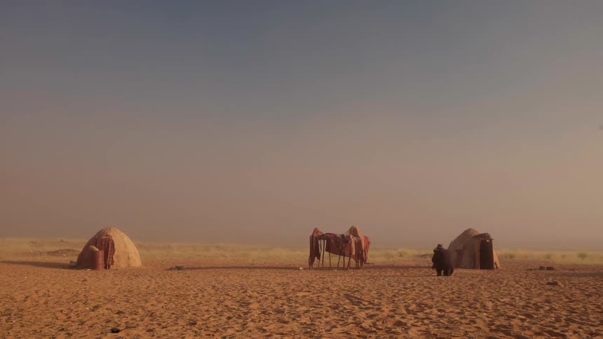 Huts are set up in the desert ahead