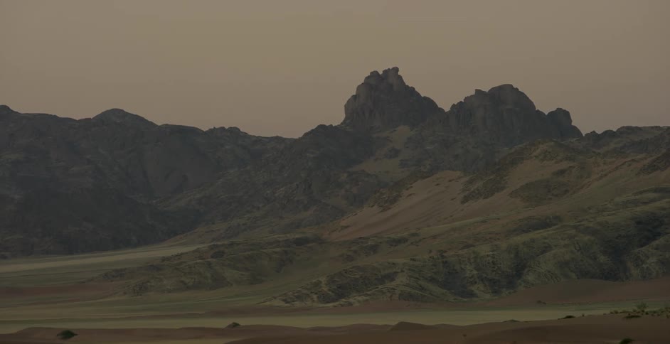 A valley with a mountain in the background
