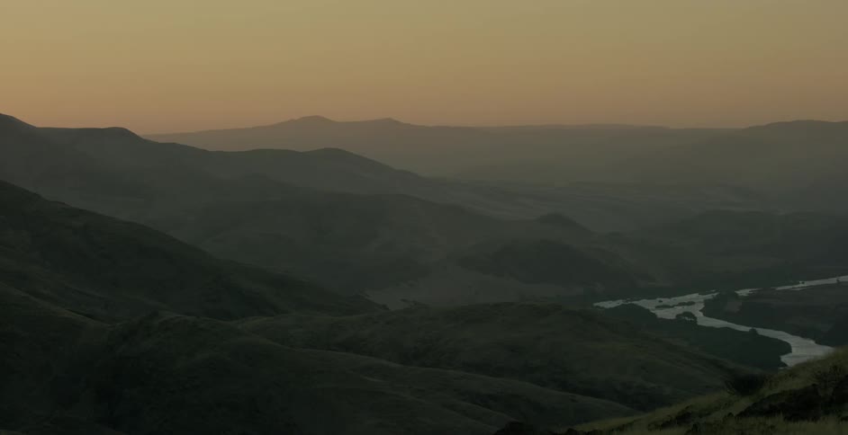The mountains are covered in fog at dawn