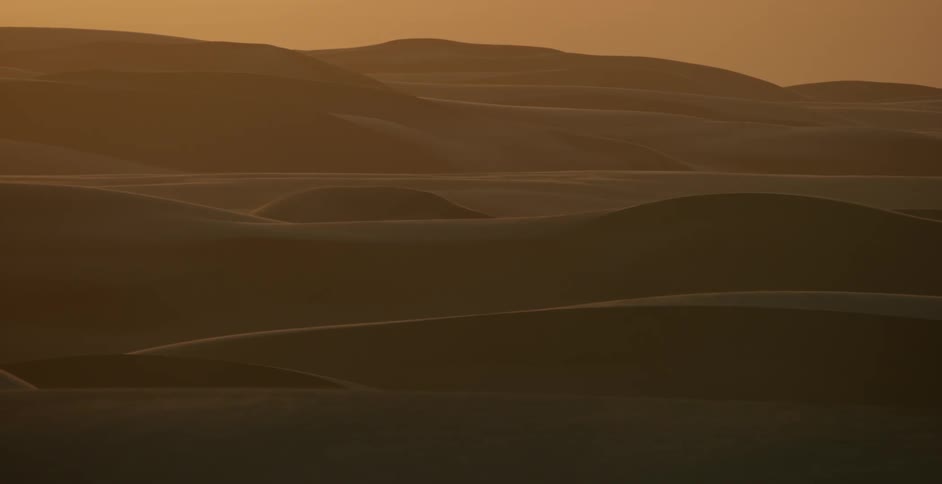 The dunes ahead are vast as the sun sets