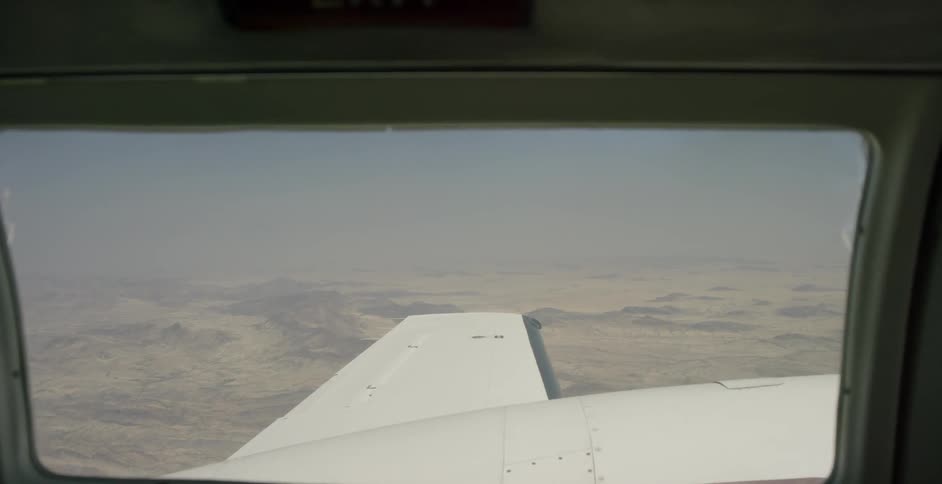 The desert is being filmed from a planes window