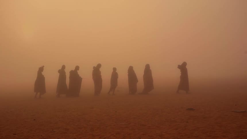 A man takes photographs of a group of people