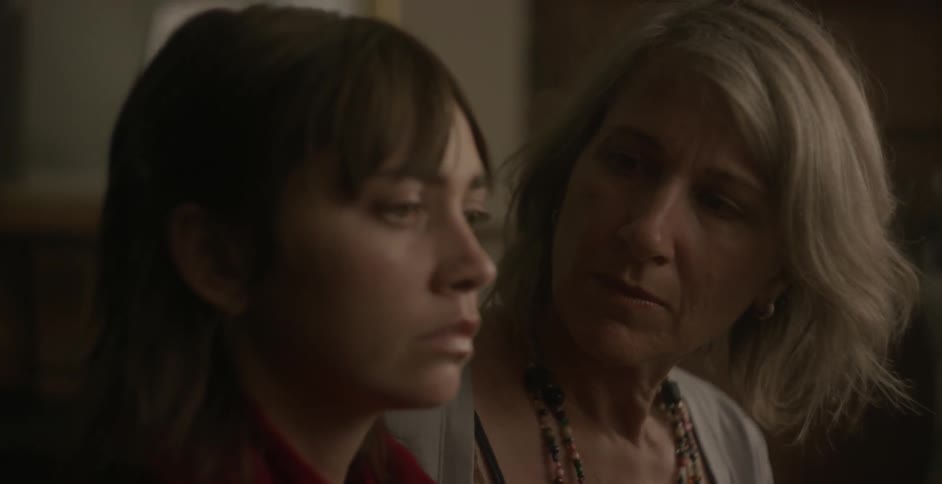A woman tries to comfort another worried looking woman