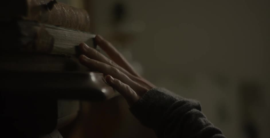 Person touching old books that are falling apart