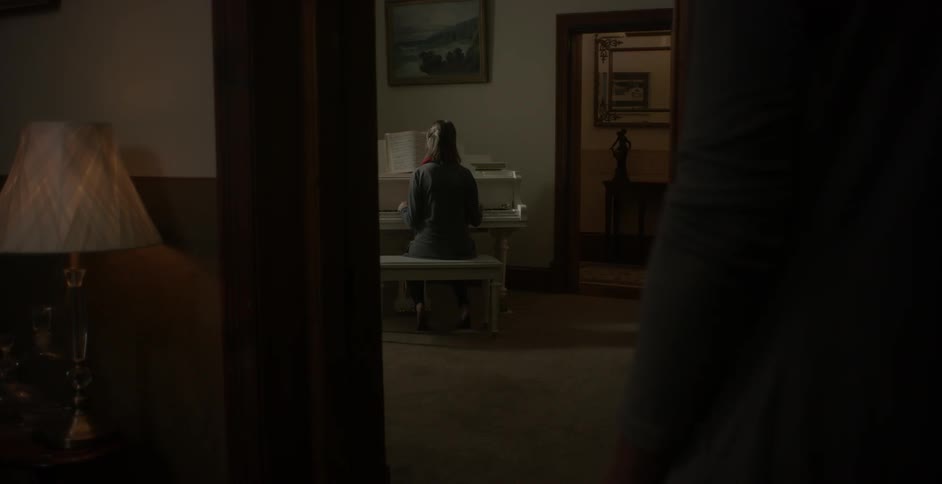 Person plays a piano in a house