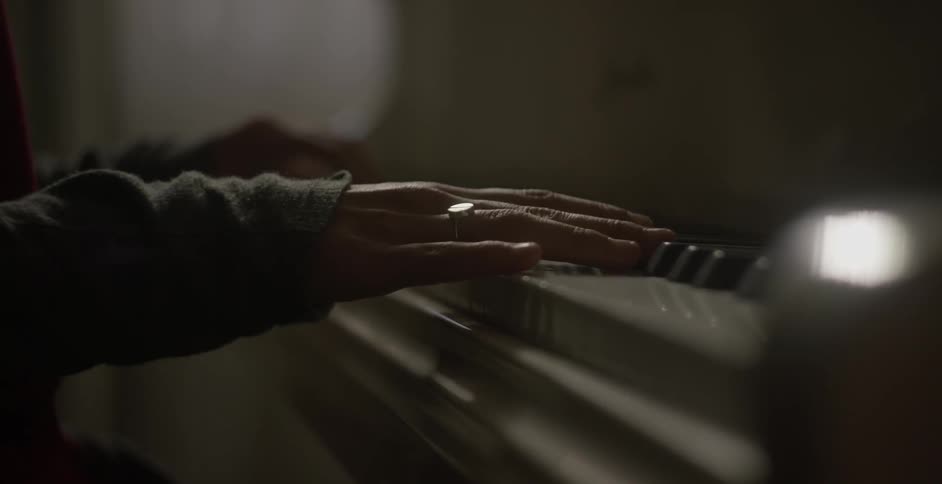A woman plays a piano