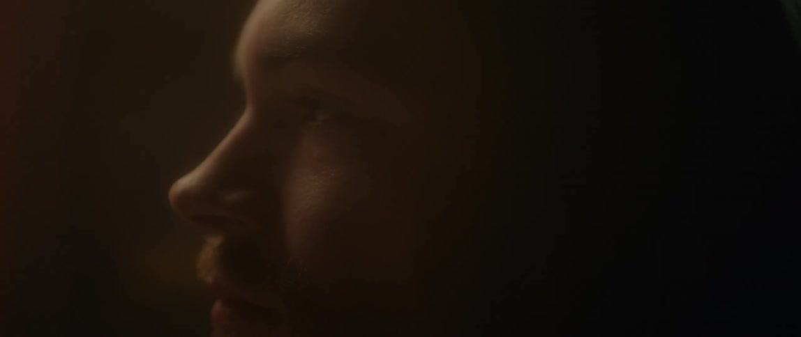 Close up of a man's face in dim light