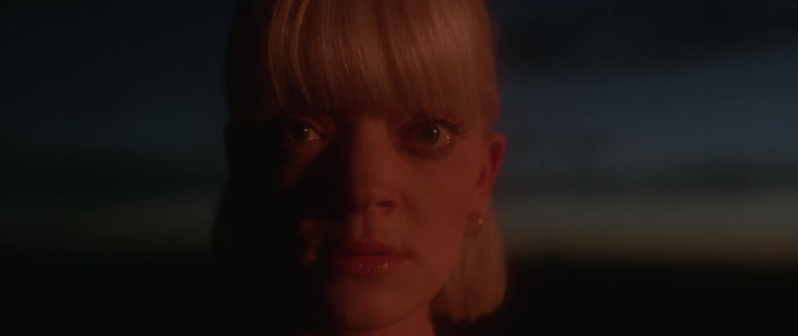 Woman with blond hair opens her eyes and then closes them again