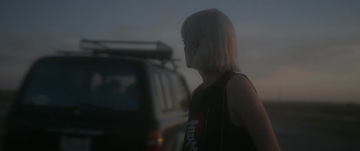 A woman gets out of a vehicle that speeds off