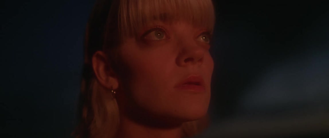 Woman's face illuminated by light at night