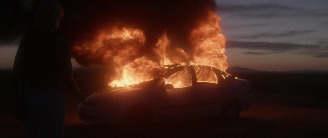 Car blazing on fire at night