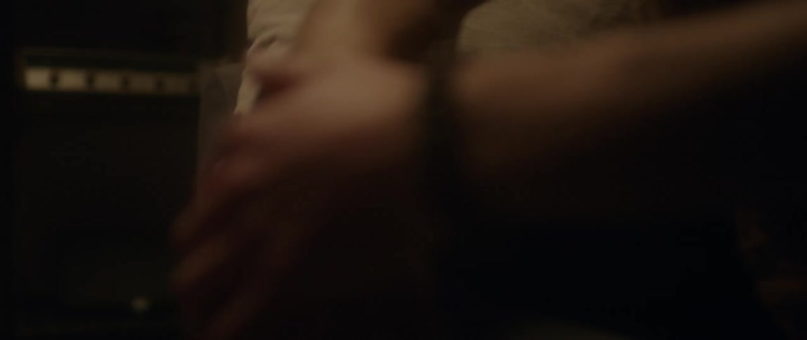 A person wearing a bracelet is rubbing their hands together