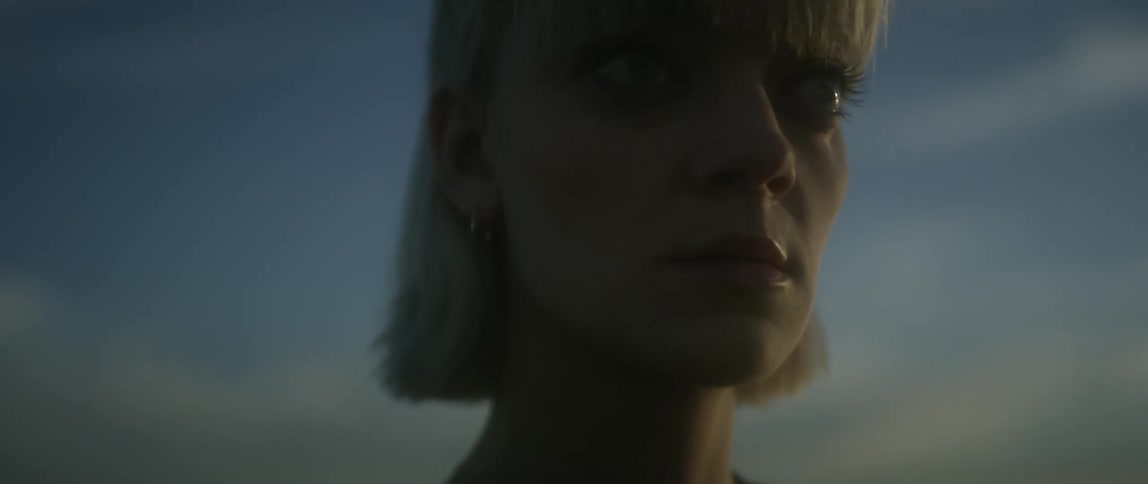 A woman looks forward upset