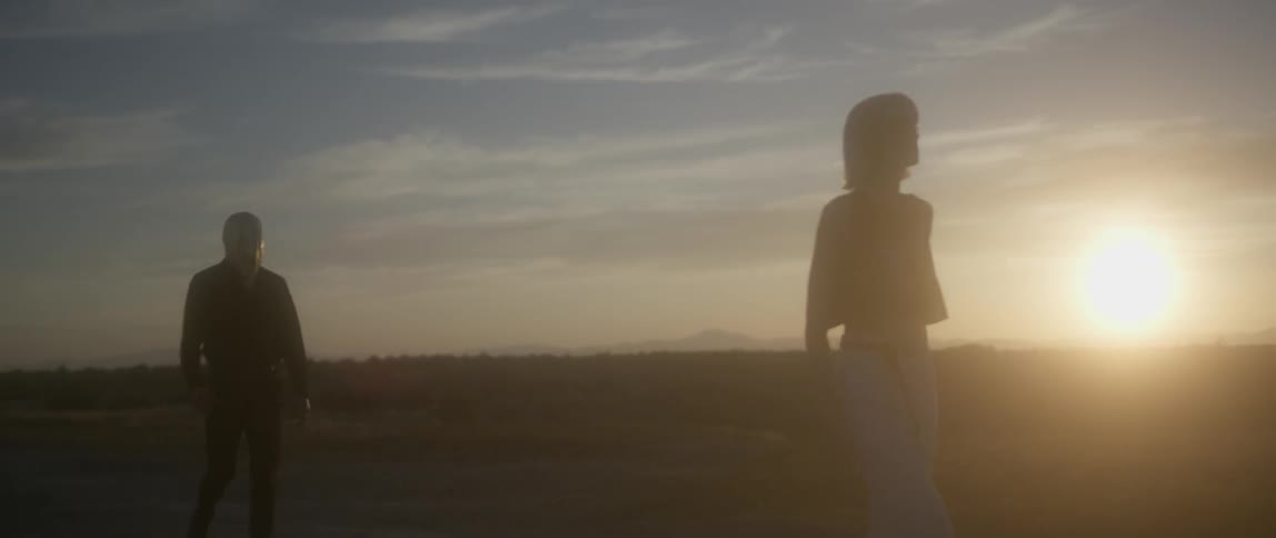 A woman is being followed by a man
