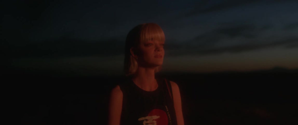 A woman is upset standing outside at dawn