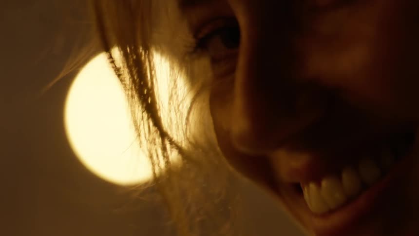 A woman looks down smiling
