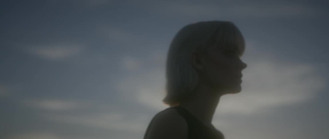 A woman is walking fast on a cloudy day