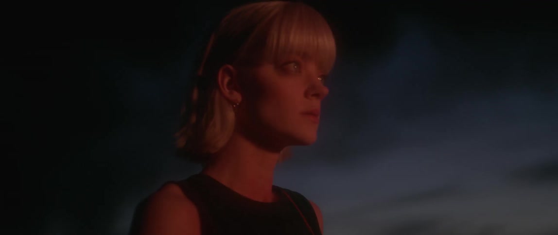A woman looks on at a dawn