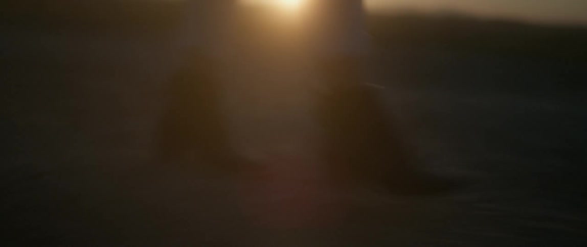 A person is walking in the desert at dawn slowly