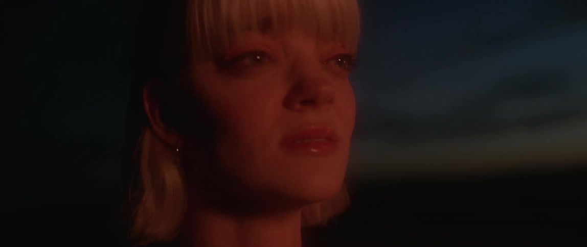 A woman is crying outside at night