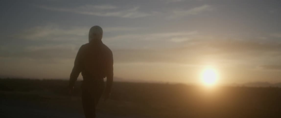 A man walks along the desert hiking