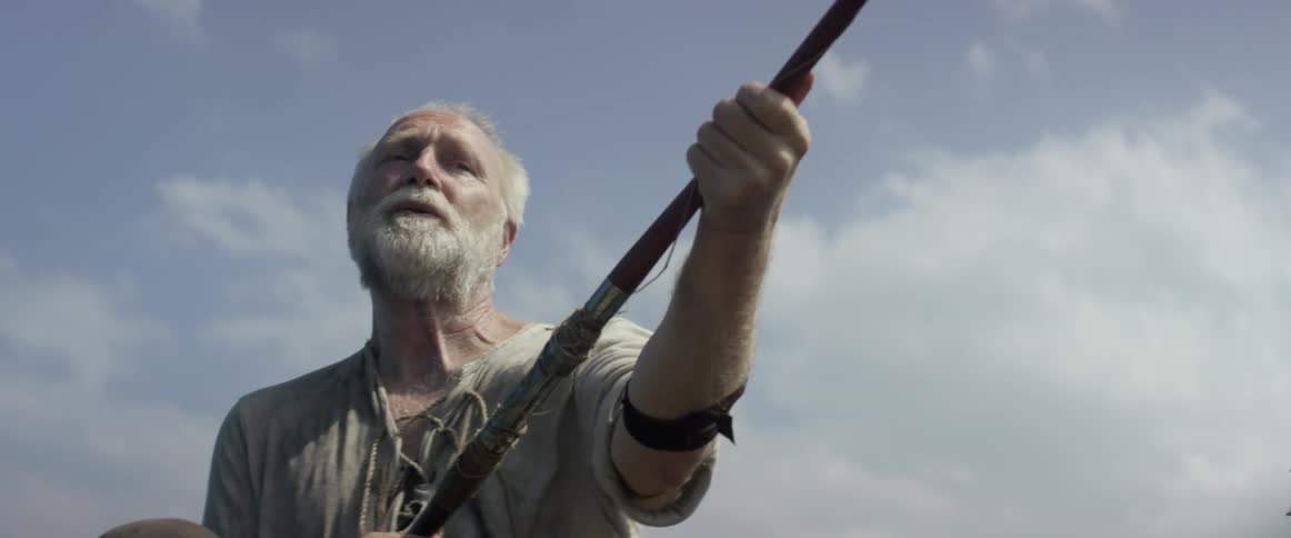 A man holds a fishing pole with both hands
